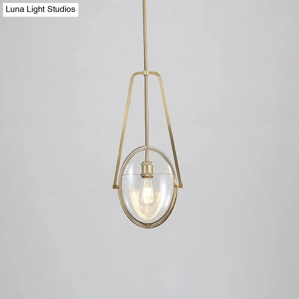 Modern Brass Pendant Light with Clear Glass Shade and Unique Halberd Frame